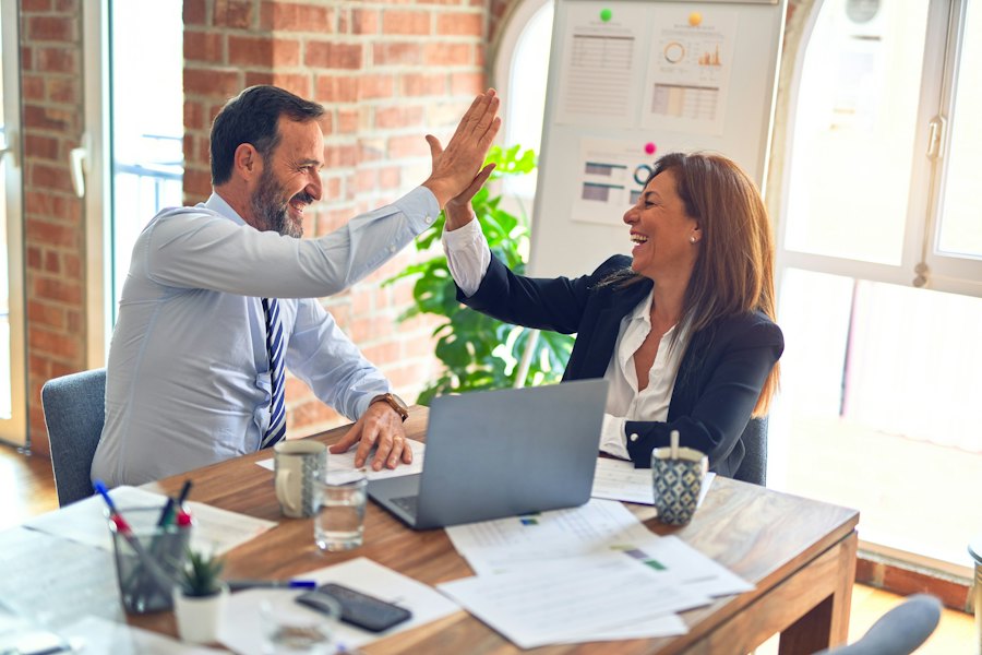 Two Canadian accounting professionals discussing bookkeeping and tax strategy for a small business client